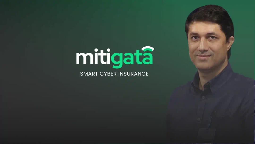 A professional portrait of Faruk Kazi set against the Mitigata brand backdrop, symbolizing expertise in cybersecurity.